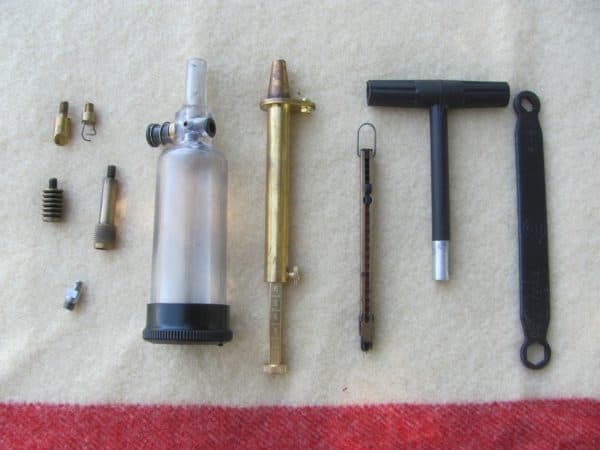 breech scraper, patch worm, 2 different patch jags, stainless nipple, powder flask, powder measure, inline capper, T-handle that is also a short-starter, breech and nipple wrench.