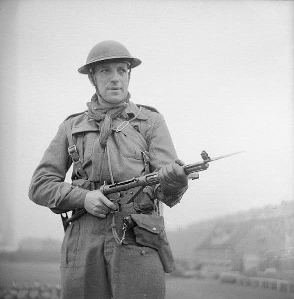 A British Army soldier holding a Sten