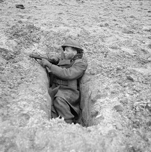 A British Soldier with a Sten in a slit trench