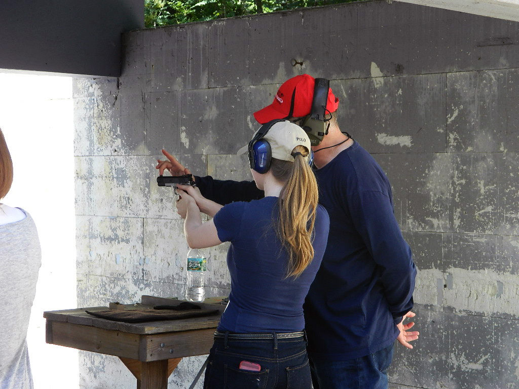 Training a teenager to shoot a handgun.