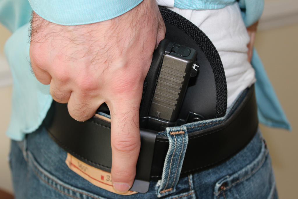 Concealed carry using waist holster