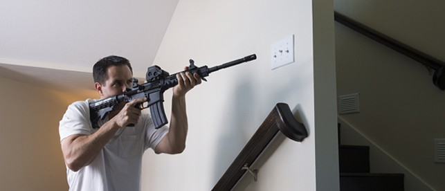 man defending home with rifle