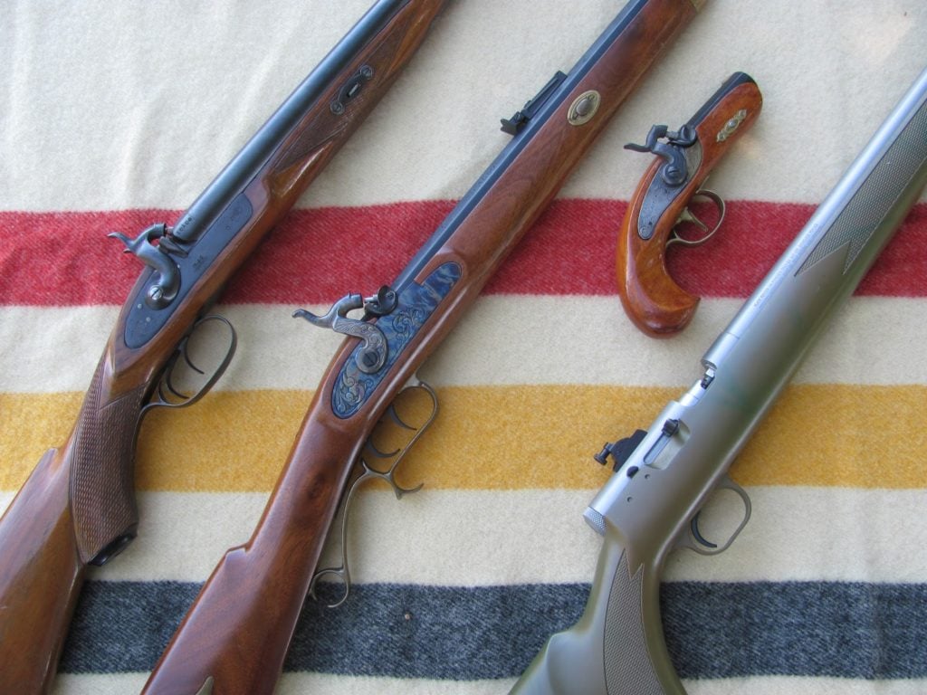 Left to Right:  Reproduction muzzleloading shotgun, Thompson/Center 50 caliber Hawken, 45 caliber Philadelphia Derringer (I made this from a kit in 7th grade woodshop! My, how times have changed), Thompson/Center Black Diamond 50 Caliber inline