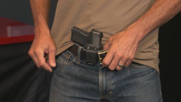 Man carrying concealed pistol in belt holster