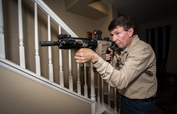 Man defending home with rifle