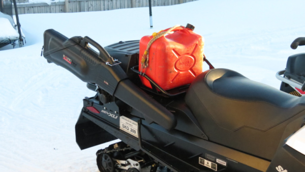 Rifle in case on back of snowmobile