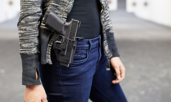 woman carrying pistol in waistband holster