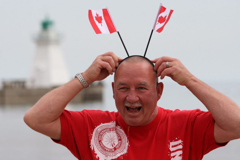 Happy Canadian with flags