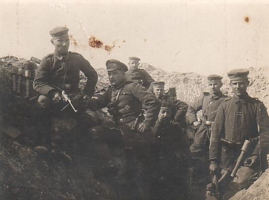 German Soldiers in a trench, one with a Luger in hand