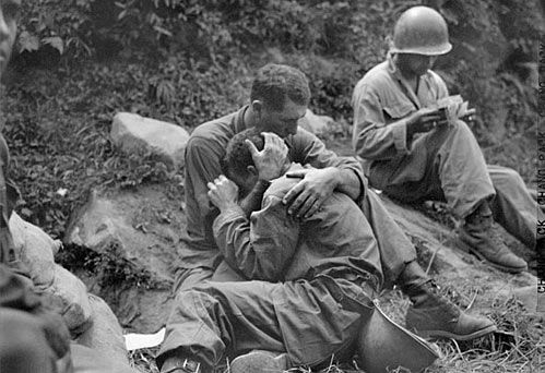 Soldiers comforting each other in the trenches