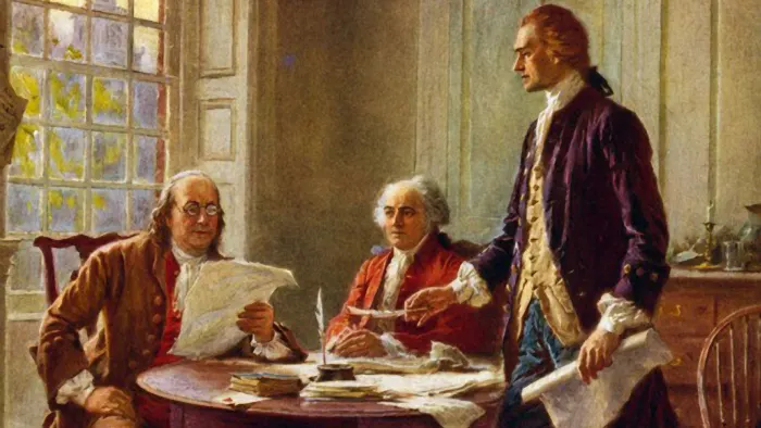 Benjamin Franklin and John Adams meeting with Thomas Jefferson, standing, to study a draft of the Declaration of Independence. (Credit: Universal History Archive/Getty Images)