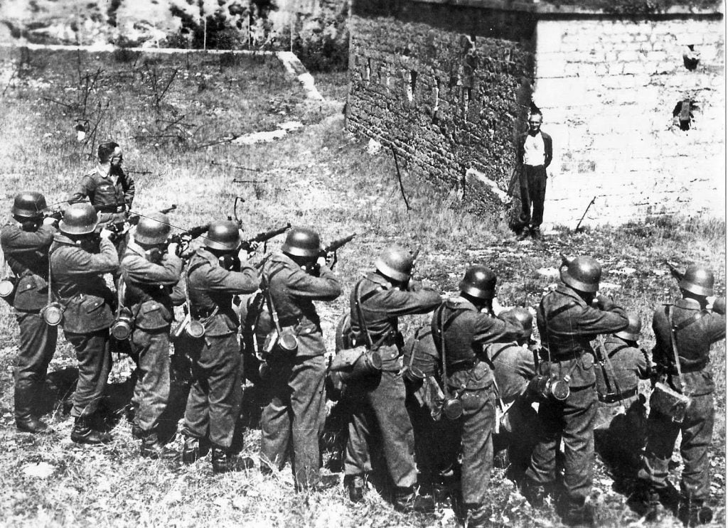 Georges Blind, a member of the French resistance, smiling at a German firing squad, 1944