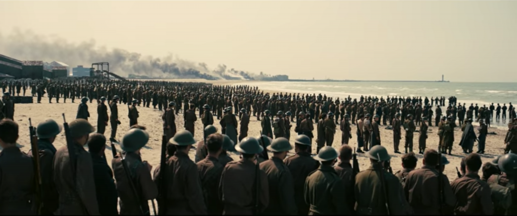 Soldiers lined up to evacuate in the film Dunkirk (2017) (Photo Warner Bros.)