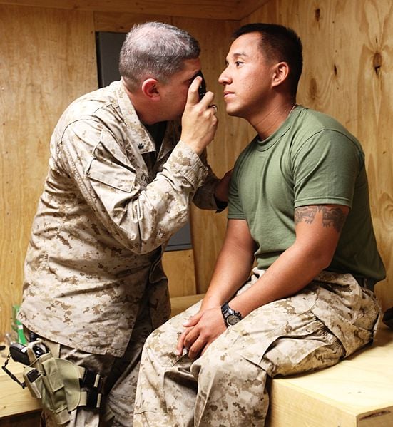 Doctor treating Marine with concussion