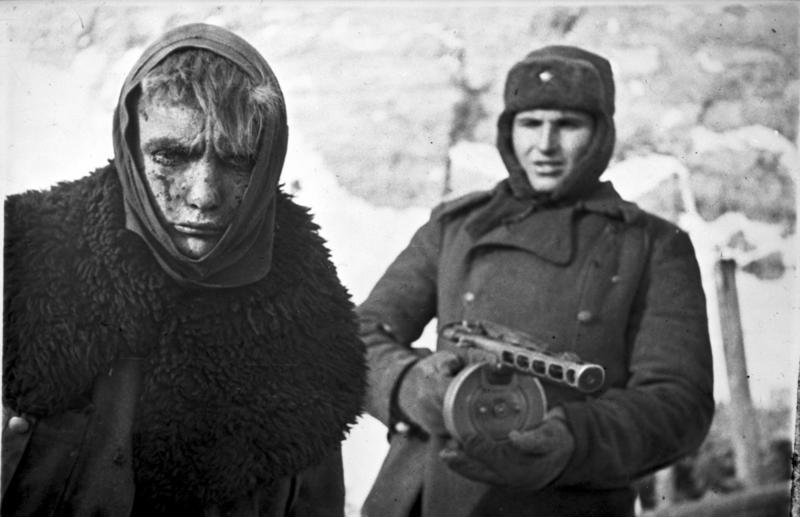 Soviet soldier armed with a PPSh-41 with a German POW