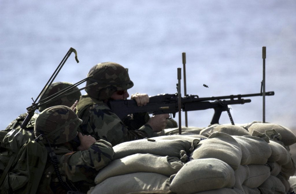 A sailor fires a M-60 machine gun during a live-fire exercise in 2003