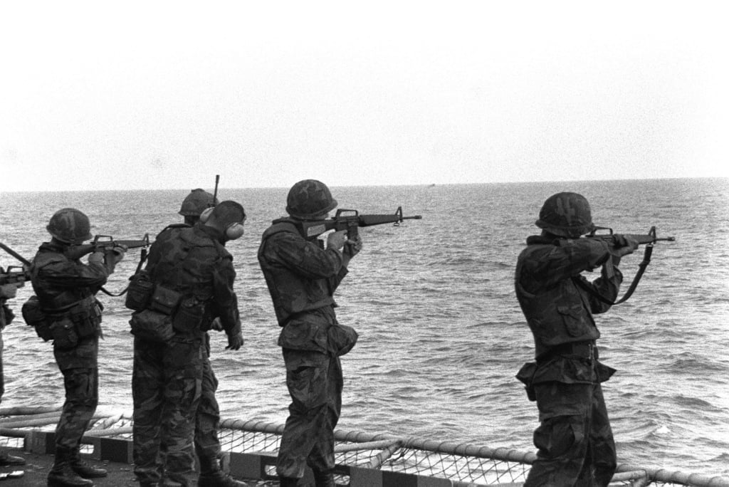 Marines practice firing M16A1 rifles off the stern of an amphibious ship prior to their arrival in Beirut, Lebanon, to participate in a multinational peacekeeping operation.